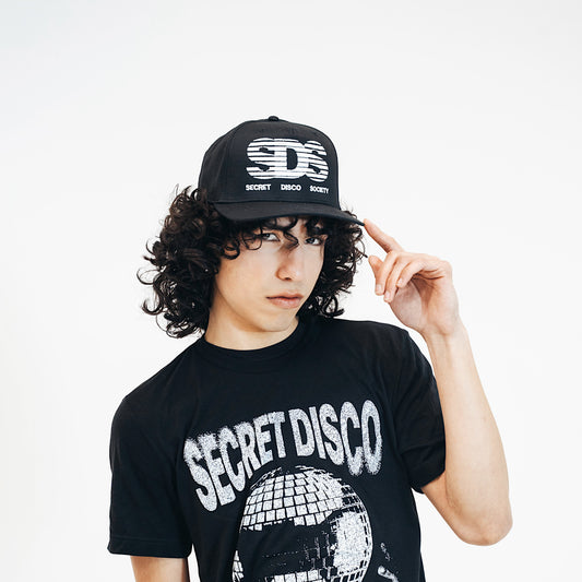 Person wearing a black 'Secret Disco' t-shirt and cap with text on a white background